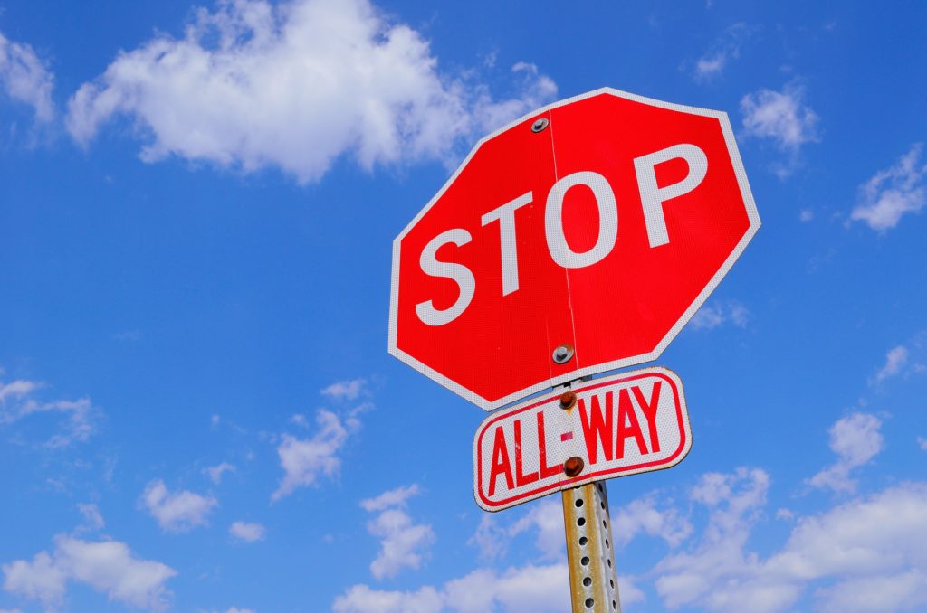 A photo of a stop sign to indicate the need for wait time.